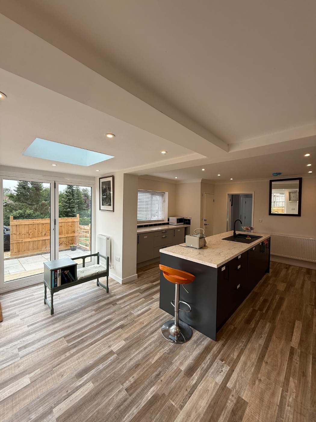 Open-plan kitchen and dining room under a skylight