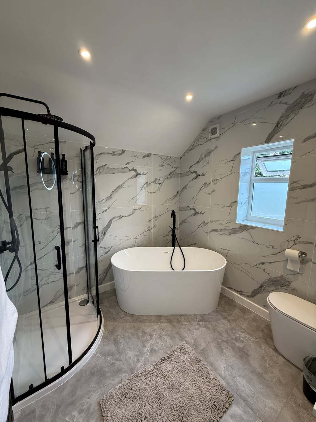 Marble bathroom with freestanding bath and walk-in shower