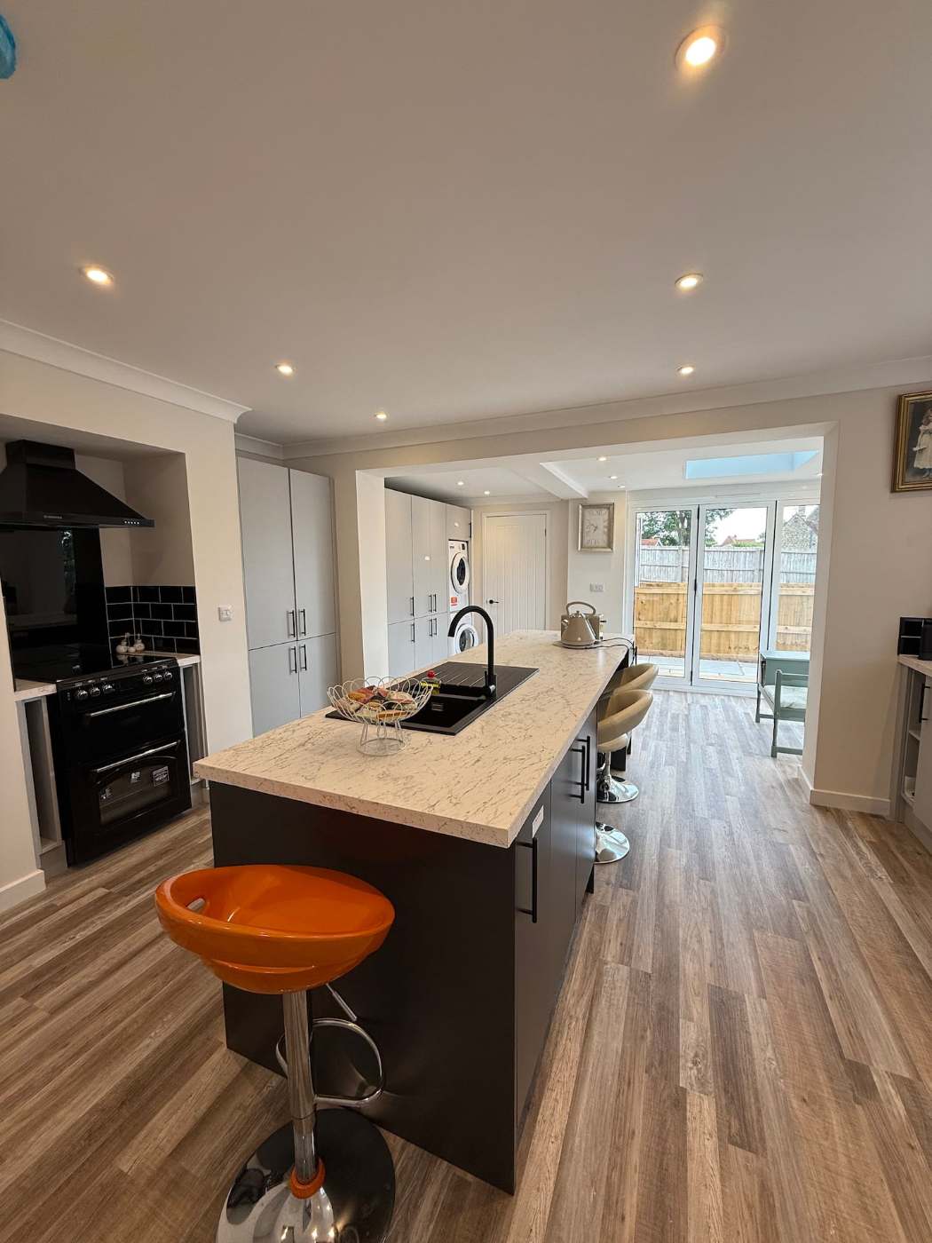 Kitchen island with orange bar stools
